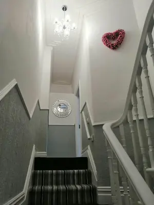 a staircase with a heart hanging on the wall at Central Luxury Town House in Blackpool