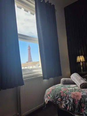 a bedroom with a window with a view of the eiffel tower at Central Luxury Town House in Blackpool