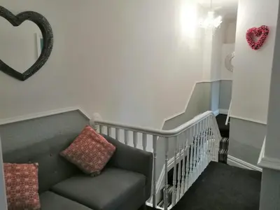 a stairway with a couch and a mirror at Central Luxury Town House in Blackpool