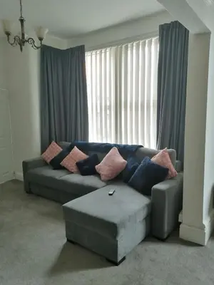 a living room with a couch with pillows on it at Central Luxury Town House in Blackpool