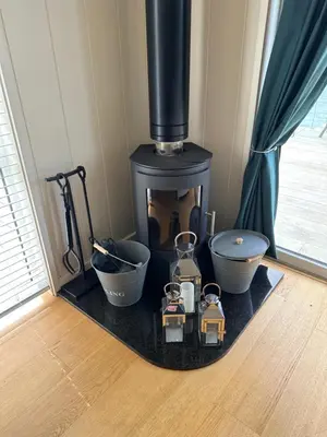 a stove with bowls and other items on a rug at Tarka Halt 1 - Haven Lakeland Leisure in Flookburgh