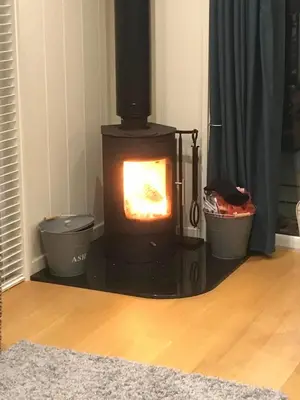 a fireplace in a living room with two pots at Tarka Halt 1 - Haven Lakeland Leisure in Flookburgh