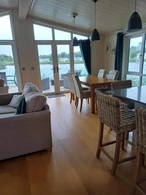 a living room with a couch and a table and chairs at Tarka Halt 1 - Haven Lakeland Leisure in Flookburgh