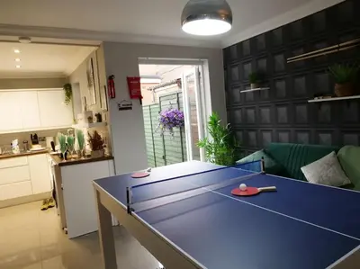 a ping pong table in the middle of a living room at Great Liverpool Location! in Liverpool