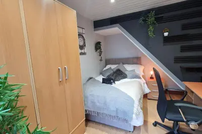a bedroom with a bed and a desk with a chair at Great Liverpool Location! in Liverpool