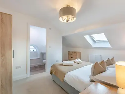 a white bedroom with a bed and a skylight at Uk46865 - Helvellyn in Ulverston