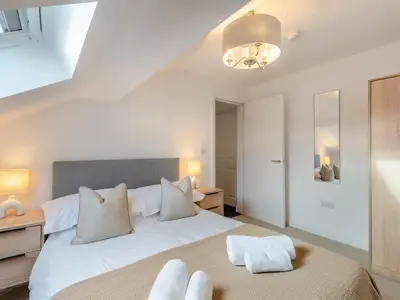 a bedroom with a large white bed with white pillows at Uk46865 - Helvellyn in Ulverston