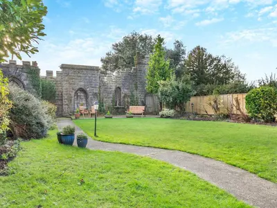a garden with a stone building and a grass yard at Uk46867 - Thirlmere in Ulverston