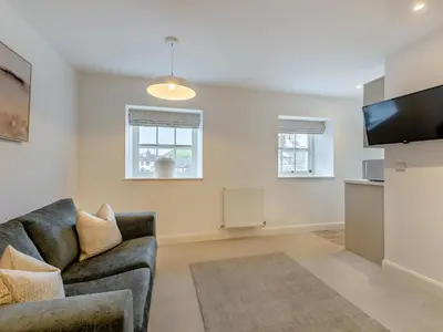 a living room with a couch and a flat screen tv at Uk46867 - Thirlmere in Ulverston