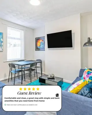 a living room with a table and a tv at Scott House - Air Host & Stay - Parking - Contractor friendly in Liverpool