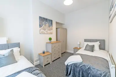 a bedroom with two beds and a dresser at Scott House - Air Host & Stay - Parking - Contractor friendly in Liverpool