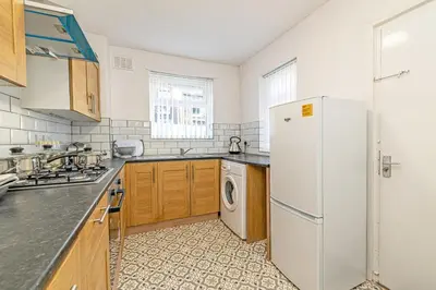 a kitchen with a white refrigerator and a dishwasher at Scott House - Air Host & Stay - Parking - Contractor friendly in Liverpool