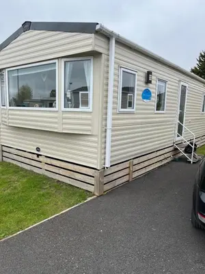 a mobile caravan is parked in a parking lot at Angella's Caravan - Morecambe in Morecambe