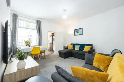a living room with a couch and a table at James Street Terrace Great Harwood in Great Harwood