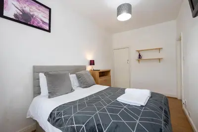 a bedroom with a large bed in a room at James Street Terrace Great Harwood in Great Harwood