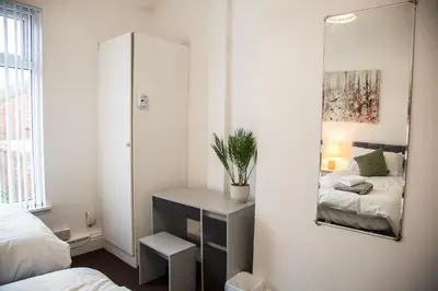 a bedroom with a mirror and a bed at Liverpool 6 beds, Up to 22 percent- Contractors Dream in Liverpool
