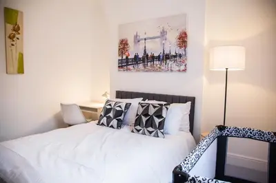 a bedroom with a bed with white sheets and pillows at Liverpool 6 beds, Up to 22 percent- Contractors Dream in Liverpool