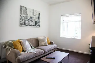 a living room with a couch and a window at Liverpool 6 beds, Up to 22 percent- Contractors Dream in Liverpool