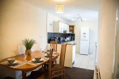 a kitchen and dining room with a table and chairs at Liverpool 6 beds, Up to 22 percent- Contractors Dream in Liverpool