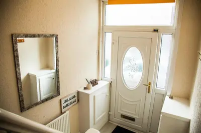 a bathroom with a white door and a mirror at Liverpool 6 beds, Up to 22 percent- Contractors Dream in Liverpool