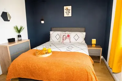 a bedroom with a bed with a plate of food on it at Haydock Cozy 2-Bedroom Home with Free Parking in Haydock