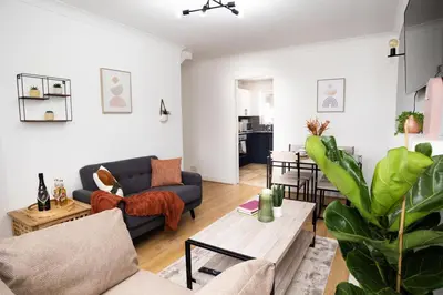 a living room with a couch and a table at Haydock Cozy 2-Bedroom Home with Free Parking in Haydock