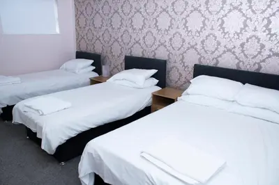 a room with three beds with white sheets at Spacious house Liverpool city centre L1, sleeps 16 in Liverpool