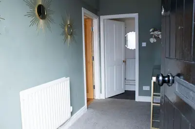 a hallway with a door and a mirror on a wall at Spacious house Liverpool city centre L1, sleeps 16 in Liverpool