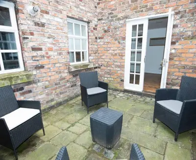a group of chairs and tables on a patio at Spacious house Liverpool city centre L1, sleeps 16 in Liverpool