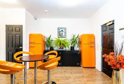 a table and chairs in a room with orange objects at Christian Retreat Holiday Let in Blackpool