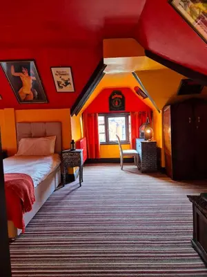 a bedroom with a bed and a red ceiling at Fifteens of Swinley in Wigan