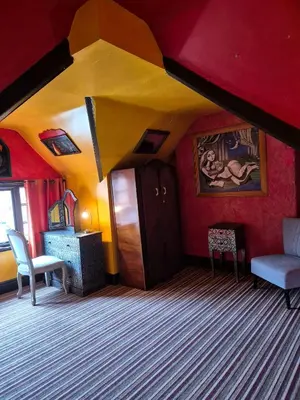 a living room with red walls and a yellow ceiling at Fifteens of Swinley in Wigan