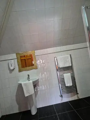 a bathroom with a sink and a mirror at Fifteens of Swinley in Wigan