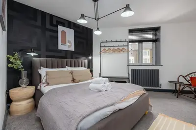 a bedroom with a large bed with a towel on it at Modern 2-Bedroom House in Blackpool Near Seafront in Blackpool