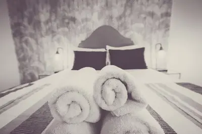 a bedroom with a bed with towels on it at Modern 2-Bedroom House in Blackpool Near Seafront in Blackpool