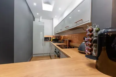a kitchen with a wooden counter top in a room at Modern 2-Bedroom House in Blackpool Near Seafront in Blackpool