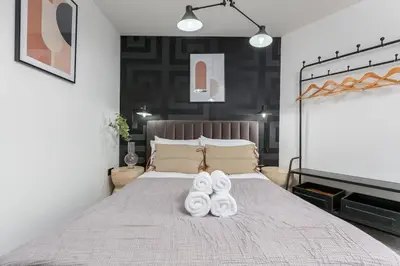 a bedroom with a bed with white towels on it at Modern 2-Bedroom House in Blackpool Near Seafront in Blackpool