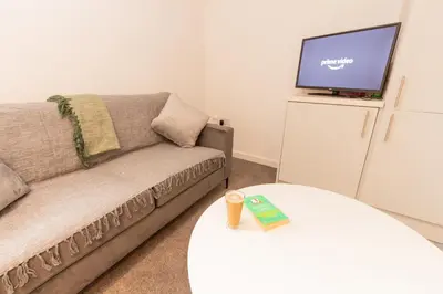 a living room with a couch and a tv at Boutique 1BR Apartment in the heart of Preston in Preston