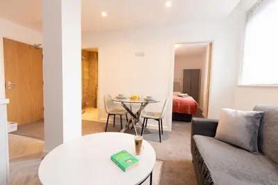 a living room with a couch and a table at Boutique 1BR Apartment in the heart of Preston in Preston