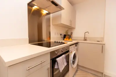 a kitchen with a sink and a dishwasher at Boutique 1BR Apartment in the heart of Preston in Preston