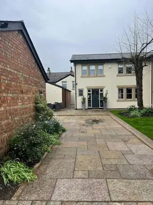 a house with a brick driveway in front of it at Cosy hideaway in leafy Lytham in Lytham St Annes