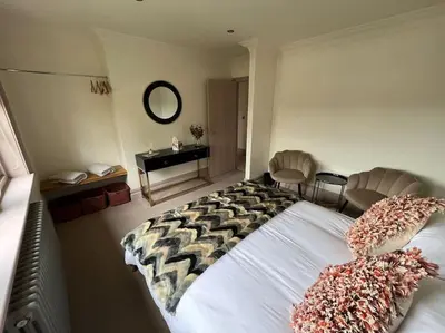 a bedroom with a large bed with two pillows on it at Cosy hideaway in leafy Lytham in Lytham St Annes
