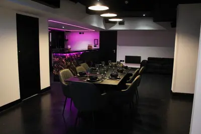 a dining room with a long table and chairs at The Hideaway by Boutique 56 in Liverpool