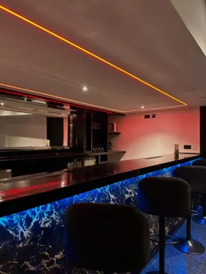 a bar in a room with a counter and chairs at The Hideaway by Boutique 56 in Liverpool