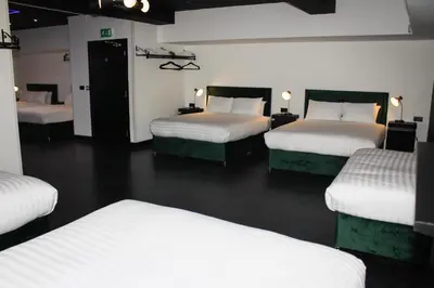 a room with four beds in a room at The Hideaway by Boutique 56 in Liverpool