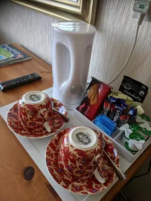 a table with two plates and a vase on it at Craigwell in Morecambe