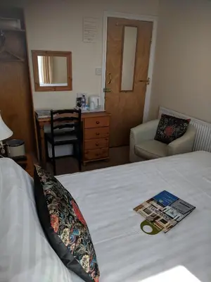 a bedroom with a bed with a magazine on it at Craigwell in Morecambe