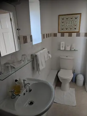 a white bathroom with a sink and a toilet at Craigwell in Morecambe
