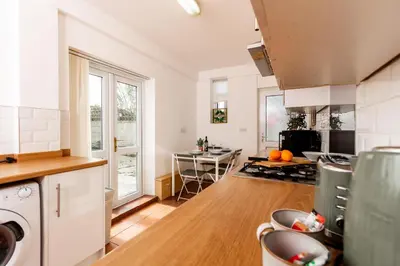 a kitchen with a stove and a counter top at Stylish Comfort: 2BR Home in the Heart of Wigan in Pemberton