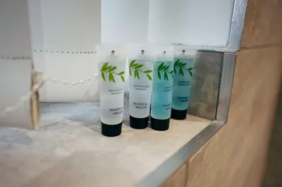 a row of four bottles of lotion with plants in them at Park & Relax in 1bd Central Liverpool home in Liverpool